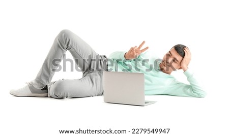 Handsome guy with laptop video chatting on white background