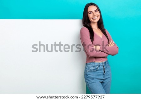 Photo of girlish cheerful girl straight hairdo pastel cardigan near white wall arms crossed isolated on vibrant teal color background