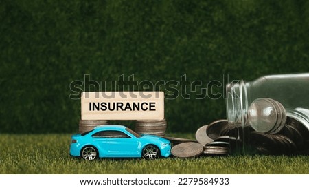 blue toy car pictures  Stacks of coins and wooden blocks  with concepts of insurance, car insurance, savings, investments and insurance brokers etc.