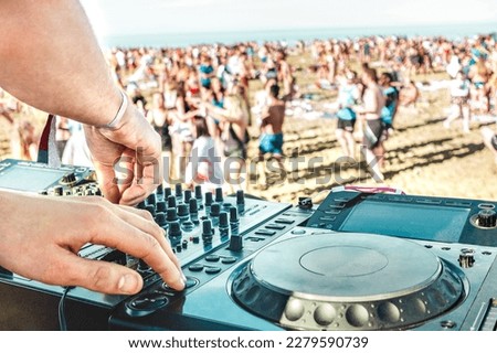 Detail of dj playing modern sound on cd usb player at spring break festival - Beach music party and life style concept - Defocused background with shallow depth of field - Bright vivid filter Royalty-Free Stock Photo #2279590739