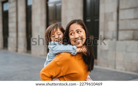 Happy southeast Asian mother with her daughter having fun in the city center - Lovely family outdoor Royalty-Free Stock Photo #2279610469