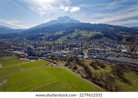 Aerial view of City of Luzern with famous Mount Pilatus in the background on a blue cloudy spring day. Photo taken March 22nd, 2023, Lucerne, Switzerland. Royalty-Free Stock Photo #2279612531
