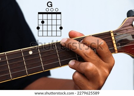 Hands holding guitar chords with basic chords, Guitar Lesson, Finger Chart Royalty-Free Stock Photo #2279625589