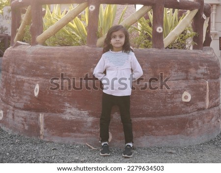 Close up headshot portrait image with smiling little brown-haired girl. Concept happy and beauty kid with good healthy of moving subject clear blur background photo.