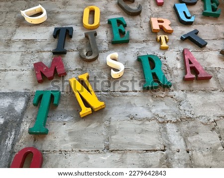 Assorted colorful letters affixed to the wall as a means of education and recognition of capital letters to children