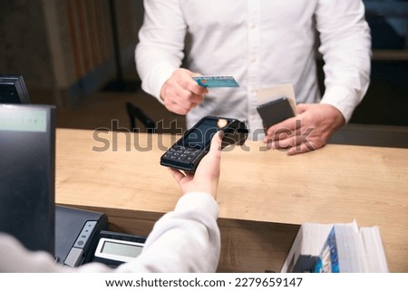 Tourist paying for hotel room at check-in