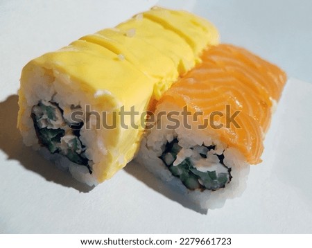 Appetizing sushi with fish and cheese close up.