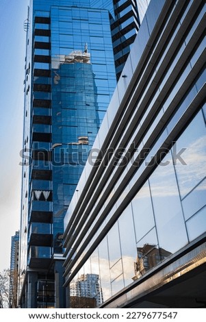Modern apartment buildings in downtown Vancouver BC Canada. Angular Glass Tower Buildings Against Blue Sky. Abstract architecture of a modern city. Vancouver city financial district-March 22,2023