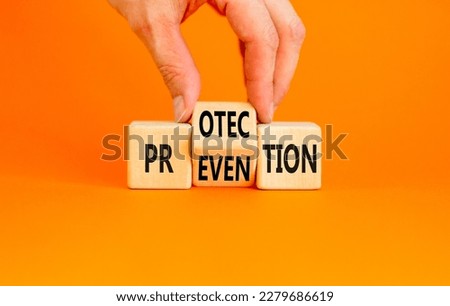 Protection and prevention symbol. Concept word Protection Prevention on wooden cubes. Businessman hand. Beautiful orange table orange background. Business protection prevention concept. Copy space. Royalty-Free Stock Photo #2279686619