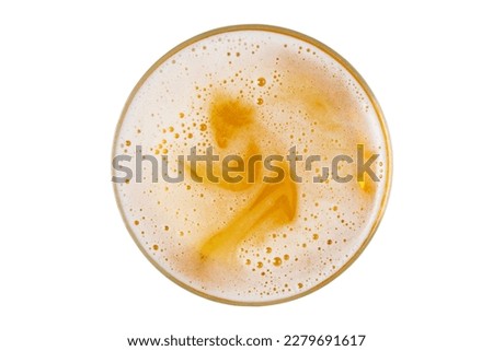 Beer in glass. Beer foam with bubble. View from above.