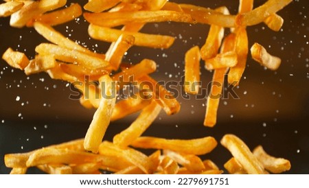 Freeze Motion Shot of Falling Fresh French Fries, Close-up Royalty-Free Stock Photo #2279691751