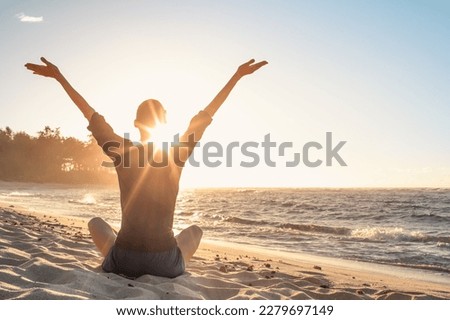 Young woman facing ocean sunset rejoices, feelings of hope, looking up to the sky, enjoys life and summer, nature, happiness. Royalty-Free Stock Photo #2279697149