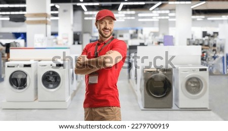 Sales manager posing inside an electrical appliance shop with washing machines Royalty-Free Stock Photo #2279700919