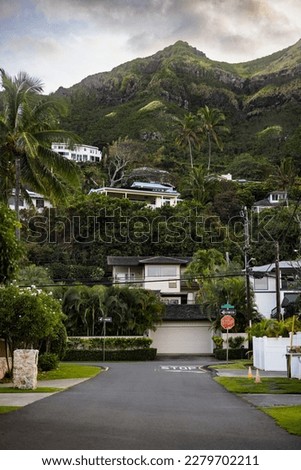 Lanikai cityscape small street in hawaii with road and houses and green mountain 