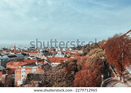 Immerse Yourself in the Stunning Beauty of Zagreb, Croatia's Capital City in Autumn with our High-Angle Photography. Our unique shot captures the city's fall colors, including the red and gold hues of