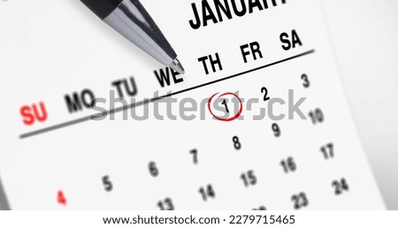Image of pen pointing to red ring over january 1st on a monthly calendar. new year and new year resolutions concept digitally generated image.