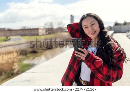 A girl taking pictures with her mobile phone