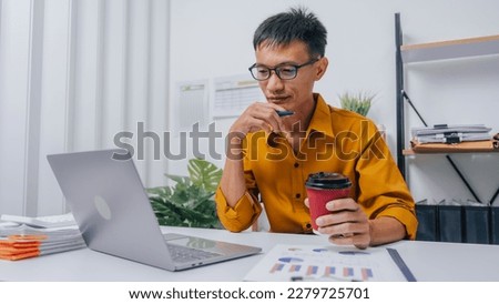 Young Serious asia people bookkeeper doing bookkeeping entrepreneur small business owner accountant in office with balance sheet, income tax return and budget of local business.