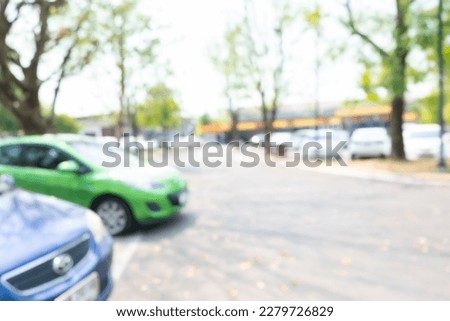 Photo of blurred parking cars in town.