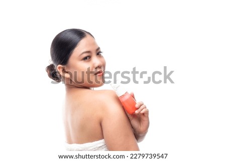 Beautiful attractive asian woman smile in bathrobe white towel after shower. touch her face for hair spa and skin care concept isolated in studio white background with copy space