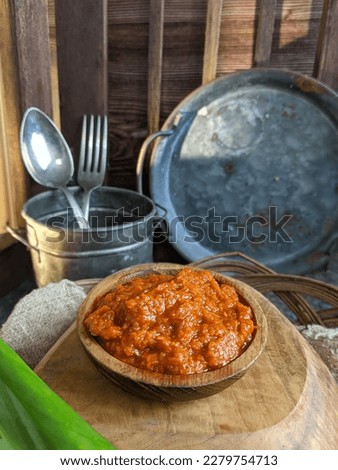 Sambal is a spicy traditional food from Indonesia made from many chillies, grainy picture with selective focus and blurred background