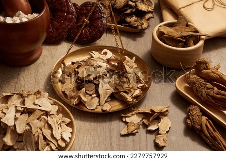 Bai Zhu placed on golden steelyard arranged with many types of herb around. Herbal medicine has played a very important role in the treatment of many different diseases Royalty-Free Stock Photo #2279757929