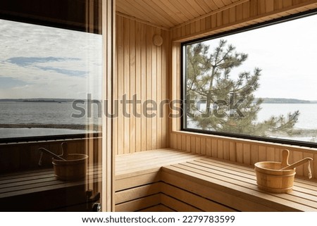 A beautiful house with a sauna and a garden near the river and a beautiful design of the house. Royalty-Free Stock Photo #2279783599