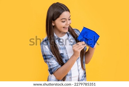 curious teen girl with birthday gift on background. photo of teen girl with birthday gift box.