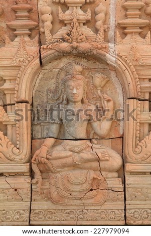 Low relief cement Thai style handcraft of hindu gods on wall.
