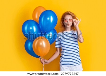 cheerful woman with birthday balloon in sunglasses. happy birthday woman hold party balloons
