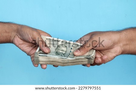 Man's Hand Giving Indian 500 Rupee Bank Notes. concept for earnings or spend in Agriculture. Royalty-Free Stock Photo #2279797551