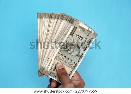 A Man Hand holding Rupees 500 bank note savings Royalty-Free Stock Photo #2279797559