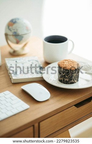 Desk office with keyboard, blank notepad, coffee cup, and muffin on wooden table, Work from home, Workspace Styled stock photography office. For template design, Flat lay copy space.