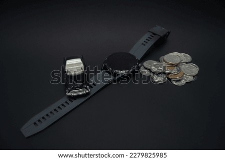 Concept for wealthiness and financial planning. A photo of a car, smartwatch, and pile of coins, after some edits.