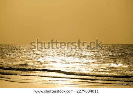 sunlight at sunset reflected on the sea surface turned into a beautiful golden color.