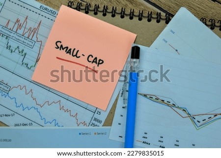 Concept of Small - Cap write on sticky notes isolated on Wooden Table. Selective focus on Small cap text