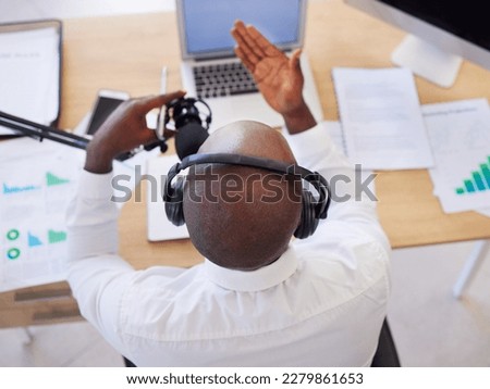 Laptop, headphones and black man with microphone for podcast, video call or live streaming in office. Business, marketing and top view of male entrepreneur with mic for content creation or radio host
