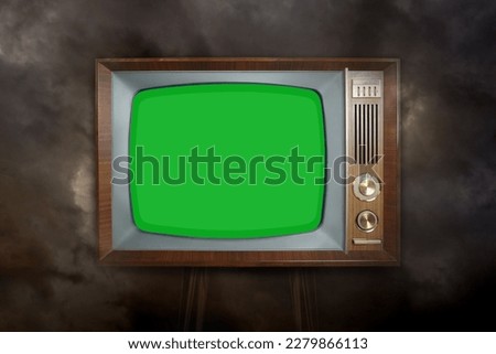 old Vintage analog TV with green blank screen, 1960-1970, concept obsolescence, modernization or technological revolution, stylish mockup, template for video, background for designer with copy space Royalty-Free Stock Photo #2279866113
