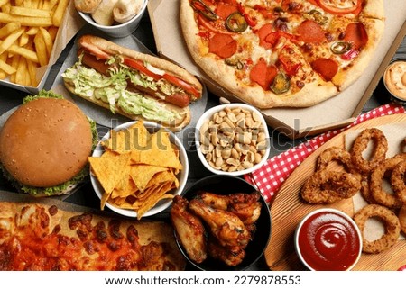Pizza, chips and other fast food as background, top view Royalty-Free Stock Photo #2279878553