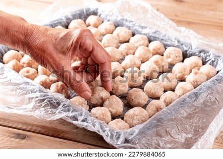 Frozen meatballs. Raw ingredients for cooking food. Frozen food Royalty-Free Stock Photo #2279884065