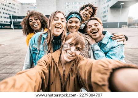 Group multiracial friends taking selfie picture with mobile smar