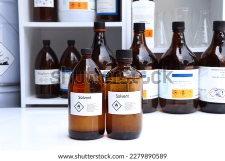 Solvent in glass,Hazardous chemicals and symbols on containers in factory or laboratory  Royalty-Free Stock Photo #2279890589