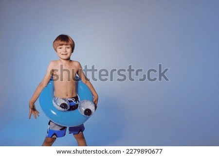 Happy cute baby boy 6-7 years old  with a life buoy. Summer and the sea. Royalty-Free Stock Photo #2279890677