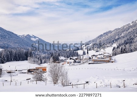 Majestic winter landscape in the alps. Snowy mountains and trees. Snow covered meadow. Scenic view.