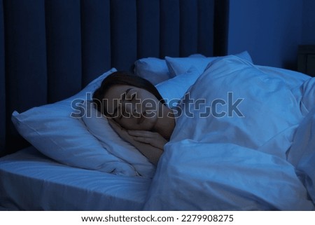 Beautiful young woman sleeping in bed at night Royalty-Free Stock Photo #2279908275