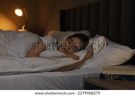 Beautiful young woman sleeping in bed at night Royalty-Free Stock Photo #2279908279