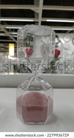 pink sand timer in the table
