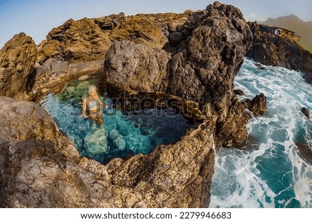 Beautiful female swimmer in bikini enjoying the stunning natural pools in the Canary Islands Royalty-Free Stock Photo #2279946683