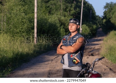 Portrait of a young man with a motorcycle.