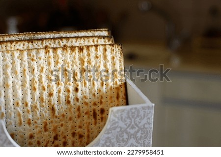 Jewish holiday Passover background. Matzah in a special box (with an inscription "matzo"),  on the kitchen